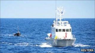 Japanese Coast Guard tows the vessel to port on 13 September 2011