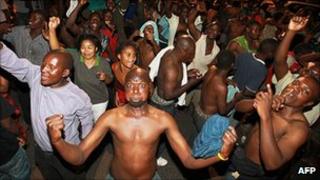 People celebrate in Lusaka early on 23 September 2011