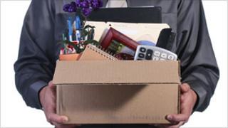 Man in suit carrying a box