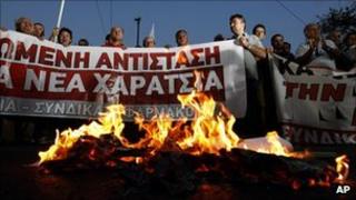 Greek demonstrators burn copies of emergency tax notices