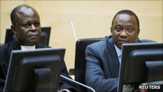 Uhuru Kenyatta (R)attends a hearing at the International Criminal Court (ICC) in The Hague on 21 Sept