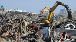 Heavy machinery cleans up tsunami devastation in Japan