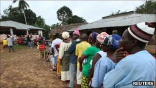 People wait to vote during the presidential election at a polling station of Allasala Town, Bomi county October 11, 2011