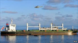 A helicopter over the Montecristo, with the RFA Fort Victoria in the background