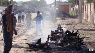 A Somali government soldiers secure the scene of a suicide attack that killed at least five people on 18 October 2011 in Mogadishu