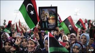 Libya women wave their new flag during celebrations in the streets of Tripoli following news of Moamer Kahdafi"s capture and death