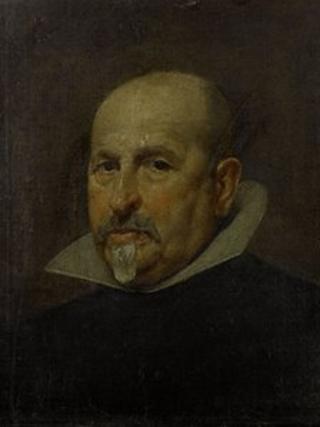 Portrait of a gentleman, bust-length, in a black tunic and white collar