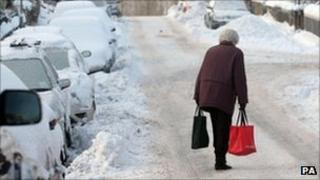 Elderly woman walking through the snow in Peebles last winter