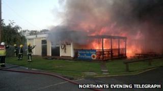 Firefighters tackle the blaze at the football club