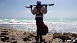 A Somali pirate looks out to sea