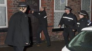 Police raid a house on Merseyside