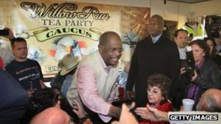 Herman Cain shakes hands at a Tea Party rally