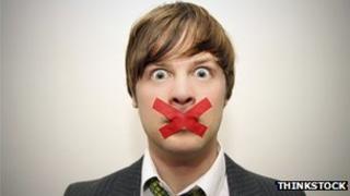 Man with tape over his mouth