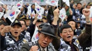 South Korean veterans and conservative activists wave the national flag during an anti-North Korea rally in Seoul on November 18