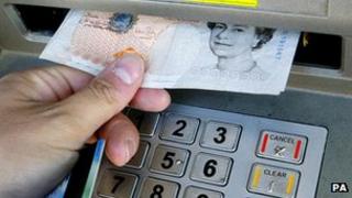 Generic pic of a person withdrawing cash from ATM