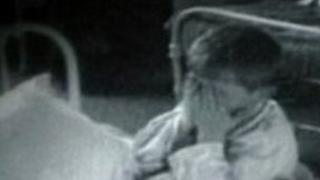 child holding hands over face