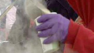A volunteer pouring soup into a cup at the Jersey Soup Kitchen