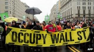 Occupy protesters march into the intersection of 16th and K Streets in Washington, DC, 7 December 2011