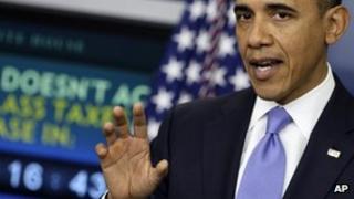 President Barack Obama gestures during a news conference in the White House 8 December 2011