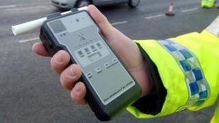 Officer holding a breath-alcohol tester