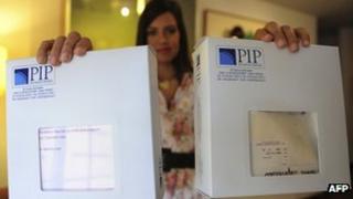 Venezuelan Vera Aulestia, 26, who has breast implants from the now-bankrupt Poly Implant Prothese (PIP), shows the boxes of the product, during an interview with AFP, in Caracas on 23 December 2011.