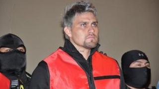 Members of Mexican police escort former goalkeeper Oscar Ortiz (C), during his presentation in Monterrey, Mexico, 7 January 2012