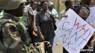 Fuel hike protesters pass a soldier in Abuja, Nigeria, 6 January
