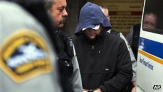 Jeffrey Paul Delisle is escorted from provincial court in Halifax, Nova Scotia, Canada on 17 January 2012