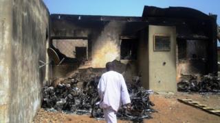A man inspects the burnt-out wreckage of motorcycles destroyed by multiple explosions and armed assailants in the Marhaba area of the northern Nigerian city of Kano, on January 21, 2012