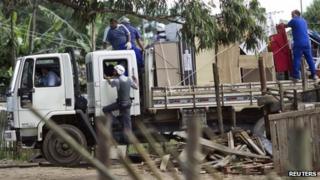 Police escort residents of the Pinheirinho slum as they remove their belongings from their homes the day after they were evicted
