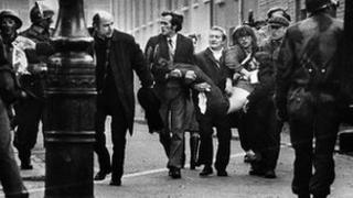 People carrying body of injured man on Bloody Sunday
