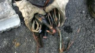 Hands grasp copper wire