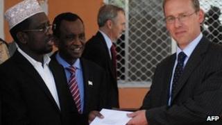Somali President Sheik Sharif Sheik Ahmed (L) receives diplomatic credentials from the Britain"s new ambassador to Somalia Matt Baugh (R) at the Hilltop presidential palace in Mogadishu, Somalia on February 2, 2012