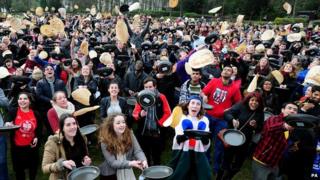 People flipping pancakes