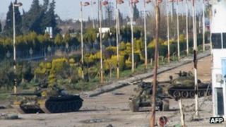 Three Syrian army tanks on a boulevard at the entrance to Baba Amr in Homs