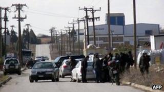Police outside the factory in Komotini where the siege was under way, 1 March