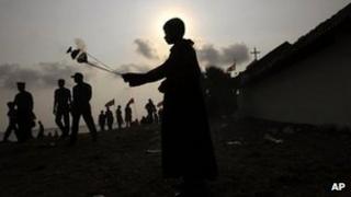 A Sri Lankan ethnic Tamil Catholic devotee swings a container of incense smoke during the annual feast at the St. Anthony"s Church in Kachchathivu, about 340 kilometers (211 miles) north of Colombo, Sri Lanka, Sunday, March 4, 2012