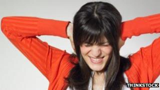 Woman covering ears