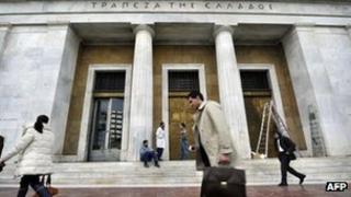 A man walks passed the Greek central bank