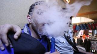 Iraqis who identify as emos smoke a water pipe in Najaf