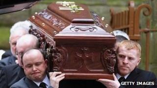 Celtic manager Neil Lennon (right) helps carry Paul McBride's coffin