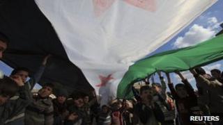 Children with a Syrian independence flag during a demonstration against President Bashar al-Assad in Hazzano, Idlib province