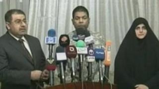 Still from video of pre-recorded news conference announcing release of US man (centre) - 17 March 2012
