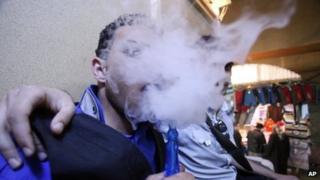 Iraqis who identify as emos smoke a water pipe in Najaf