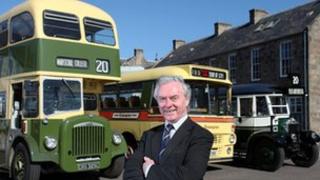 Secretary of the FirstGroup Heritage Trust, Joe Mackie, with three of the trust's vehicles