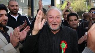 George Galloway waves to supporters before an open top bus tour in Bradford