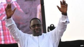 Macky Sall holding his arms in the air