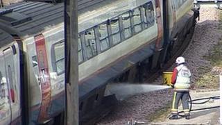 Fire crews damp down affected carriages