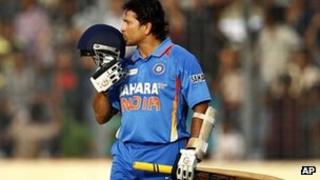 Sachin Tendulkar kisses his helmet after scoring his 100 century