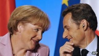 French President Nicolas Sarkozy looks at German chancellor Angela Merkel as he participates in a press conference in 2008